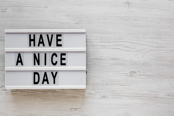 \'Have a nice day\' words on a lightbox on a white wooden surface,