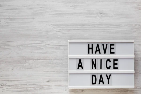 \'Have a nice day\' words on a lightbox on a white wooden surface,