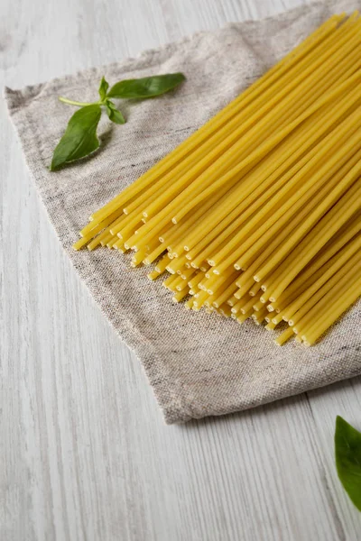 Uncooked Dry Bucatini Pasta White Wooden Background Side View Copy — Stock Photo, Image