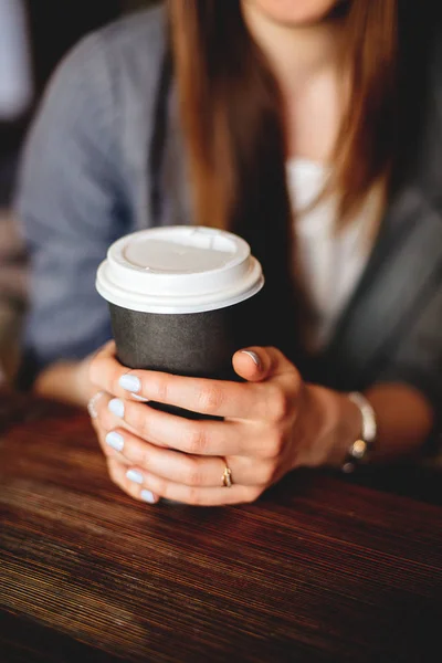 Cup of coffee in hand.