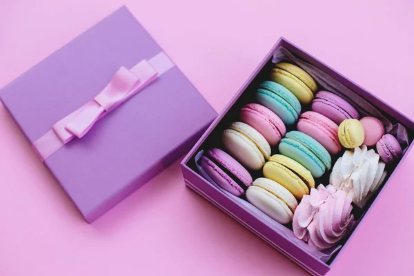 Gift box with macaroons and marshmallows.