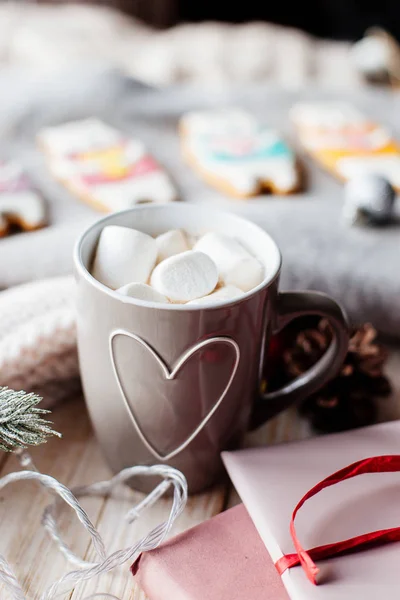 Cup of cocoa with marshmallows on table.
