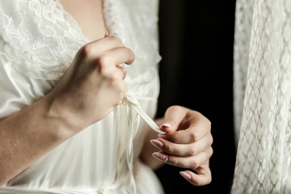 Girl ties  belt on her robe standing near window,woman getting ready before wedding ceremony — Stock Photo, Image