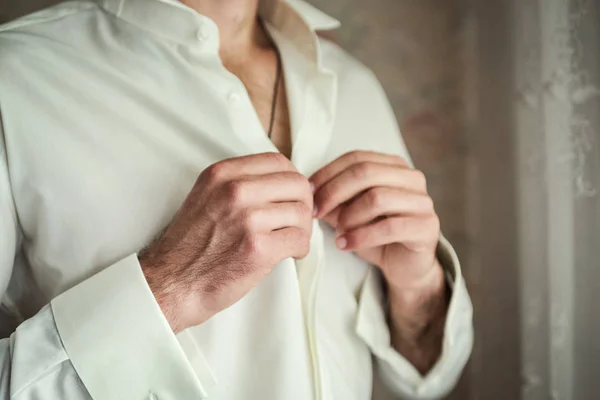 Hombre de negocios viste camisa blanca, manos masculinas primer plano, novio preparándose en la mañana antes de la ceremonia de boda — Foto de Stock