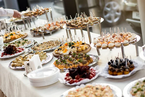 Holiday buffet table served by different canape, sandwiches, snacks ready for eating in restaurant — Stock Photo, Image