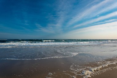 Issız bir sahilde okyanus dalgaları.