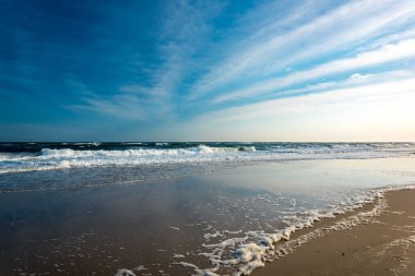 Ocean waves at a deserted beach clipart