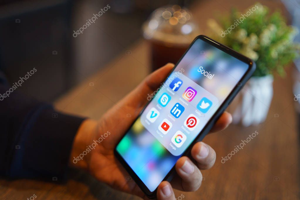 CHIANG MAI, THAILAND - Mar. 24,2019: Man holding Xiaomi Mi Mix 3 with icons of social media on the screen.Social media are most popular tool. Smartphone lifestyle. Starting social media app.