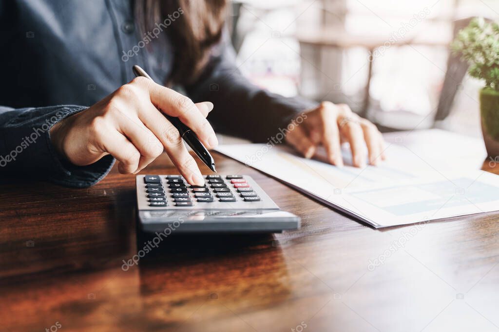 Businesswoman working on calculator to calculate business data the financial.