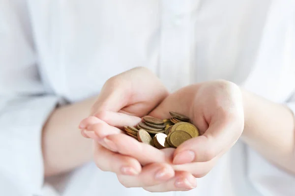 Handful of coins in palm hands isolated on white. economic crisis. Save Money. Help other people