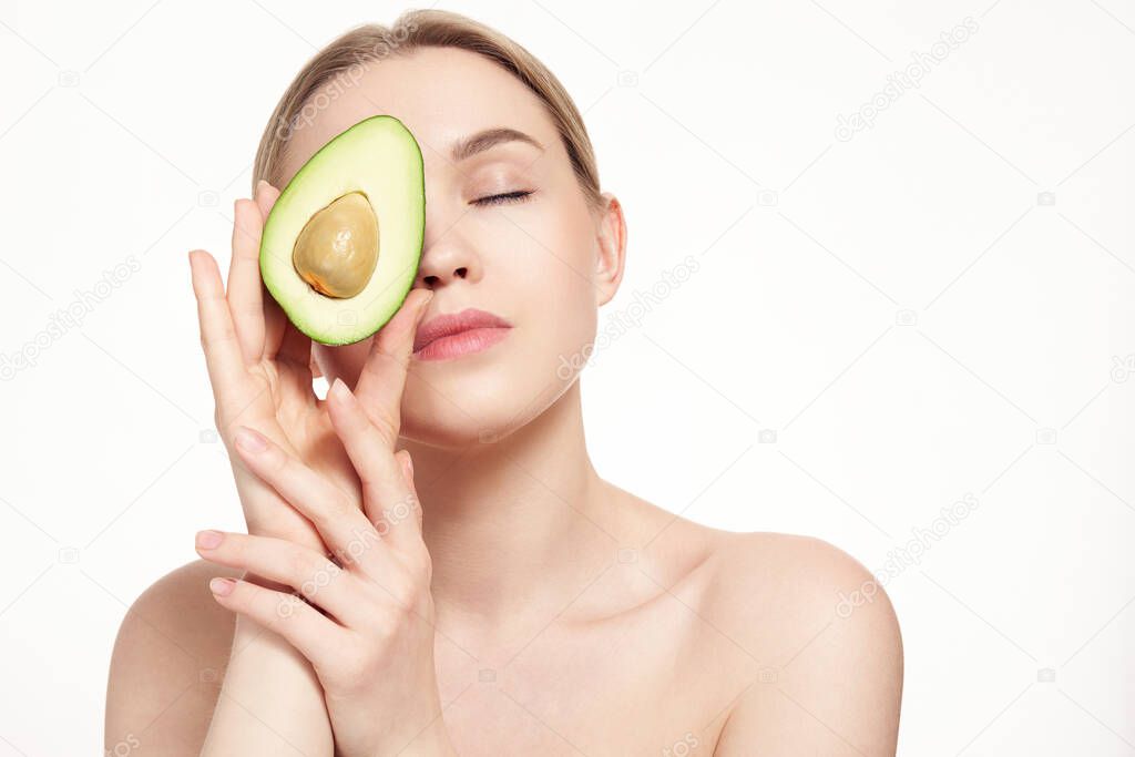 portrait of attractive caucasian smiling blonde woman isolated on white studio shot with avocado. Positive nude natural woman. Skin care. Clean fresh skin. healthy lifestyle.