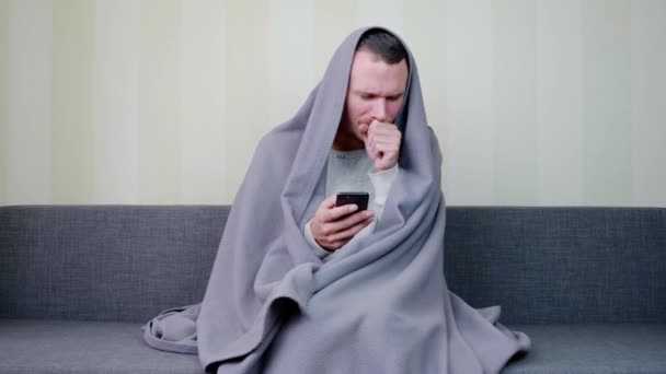 Sick Man Covered Blanket Uses Smartphone Coughs Upset Young Guy — Stock Video