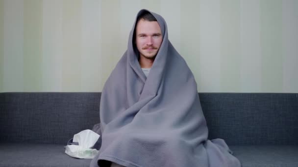 Sick Man Covered Blanket Looks Camera Young Guy Sitting Couch — Stock Video