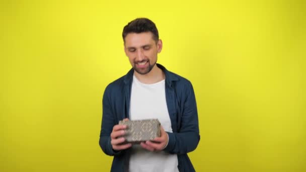 Young Man White Shirt Catches Box Gift His Hands Looks — Stock Video