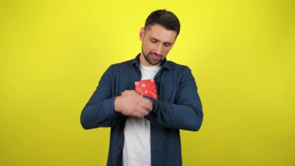 Young Man White Shirt Hugs Box Gift Looks Camera Smiles — Stock Video