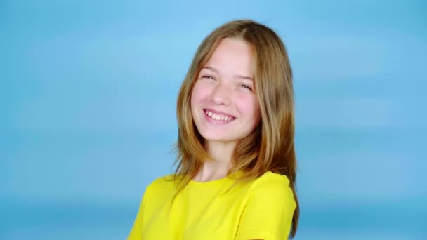 Happy Teen Girl Yellow Shirt Laughing Looking Camera Blue Background — Stock Video