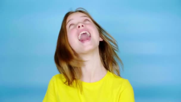 Happy Teen Girl Yellow Shirt Laughing Fooling Blue Background Copy — Stock Video