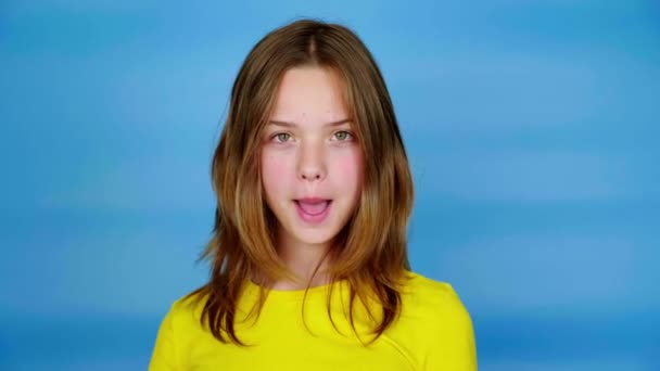 Teen Girl Yellow Shirt Looks Camera Says Stop Blue Background — Stock Video