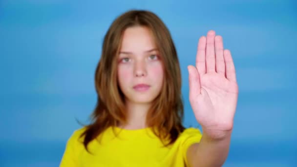 Teen Girl Yellow Shirt Looks Camera Holds Out Her Hand — Stock Video