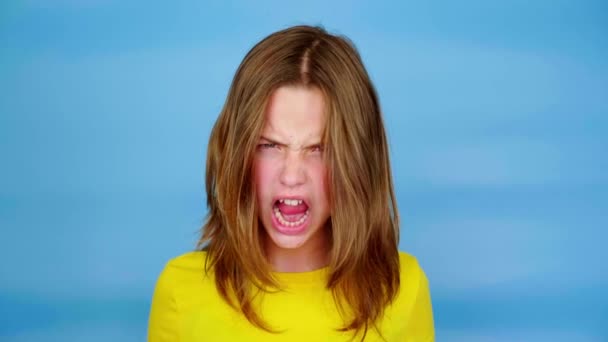 Teen Girl Yellow Shirt Screaming Smiling Grimaces Blue Background Copy — Stock Video