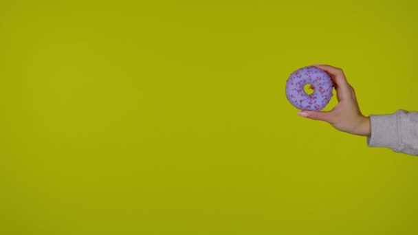Female Hand Holding One Blue Tasty Fresh Donut Isolated Yellow — 비디오