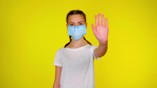 Teen Girl Medical Mask Looks Camera Holds Out Hand Front — Stockvideo