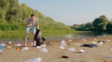 Man is collects plastic trash on polluted river and listens favorite song