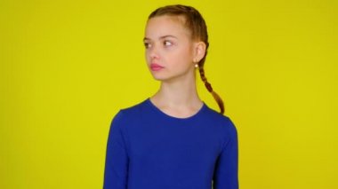 Teen girl in blue pullover looks around at places text