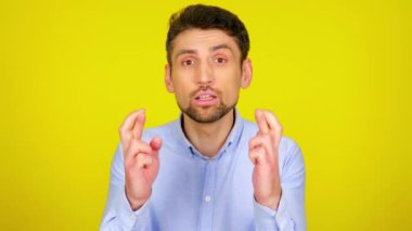 Superstitious guy crossed his fingers and prays, then enjoy the victory.