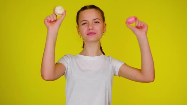 Adolescente em uma camiseta branca está dançando com macaroons — Vídeo de Stock