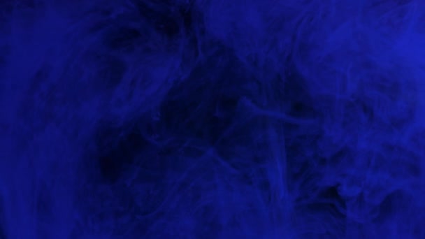 Dark blue ink mixing in water, swirling softly underwater. Art background — Stock Video