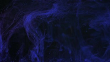 Suda mavi mürekkep karışıyor, suyun altında yavaşça dönüyor. Sanat arkaplanı