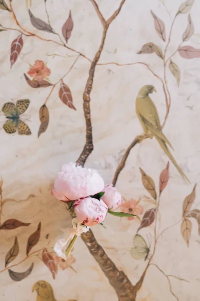 Bunch of peonies on wallpapers with floral print