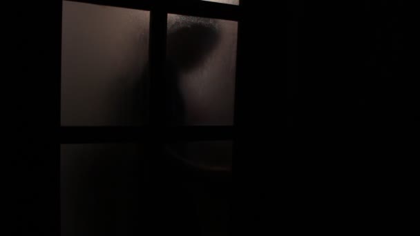 Man Opens Glass Door Person Enters Dark Room — Stock Video