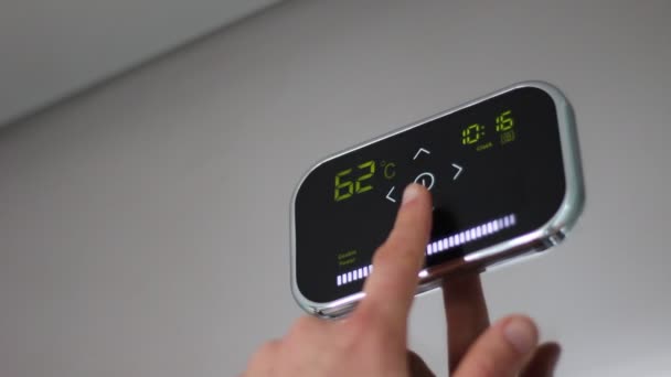 Smart thermostat. Touch Panel. Digital programmable thermostat. The user adjusts the temperature. Controlling a home's heating. Energy saving — Stock Footage Smart Thermostat Touch Panel Digital Programmable Thermostat User Adjusts Temperature Stock Footage