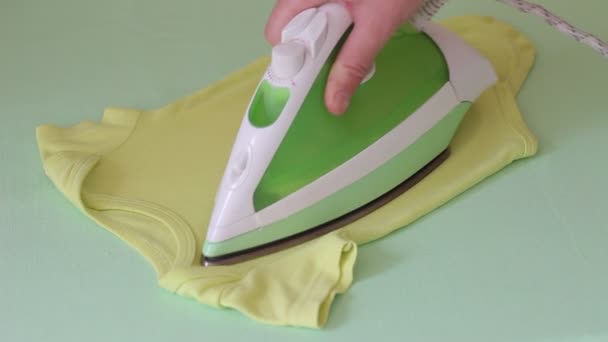 Washing, Ironing and folding newborn clothes. Ironing baby's clothes — Stock Footage Washing Ironing Folding Newborn Clothes Ironing Baby Clothes Stock Video