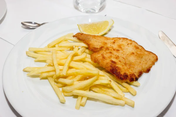 Tasty schnitzel with potato chips — Stock Photo, Image