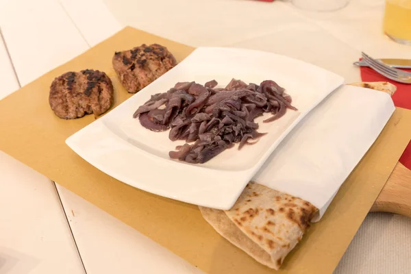 Piadina Romagnola with sausage and onion — Stock Photo, Image