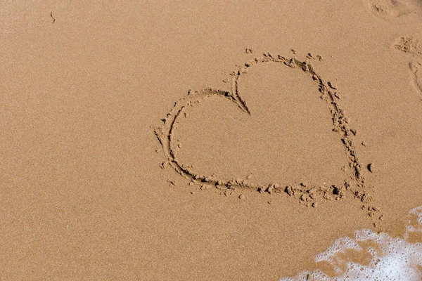 Heart draw on the shore of the sea Royalty Free Stock Photos
