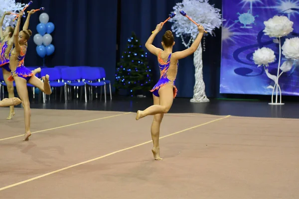 Orenburg, Rusia - 25 de noviembre de 2017 año: las niñas compiten en gimnasia rítmica realizan ejercicios con clubes deportivos —  Fotos de Stock