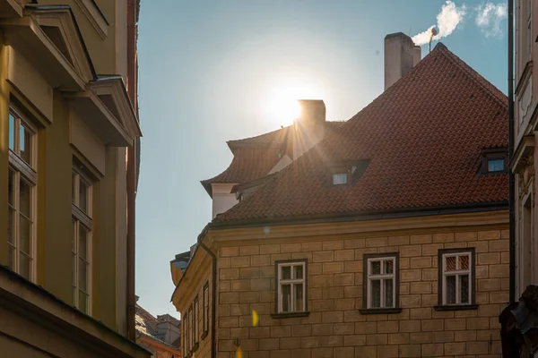 Sun Light Above Tile Roof Of Ancient House In Prague at Christmas Time.