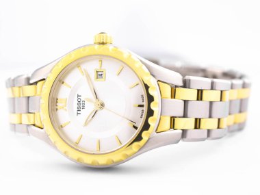 Le Locle, Switzerland 15.01.2020 - Tissot woman watch stainless steel case, gold PVD coating white clock face dial, metal bracelet, swiss quartz mechanical watch isolated, swiss made manufacture clipart