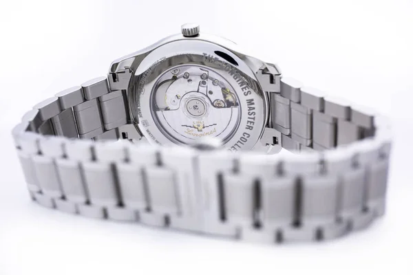 Saint-Imier, Switzerland, 2.02.2020 - Longines automatic silver steel body with bracelet watch close-up, macro isolated watch mechanism. Longines is Swiss luxury watchmaker, part of Swatch group. — Stock Photo, Image