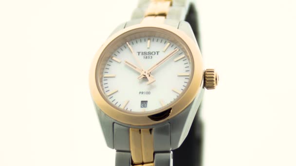 Le Locle, Switzerland 15.01.2020 - Tissot woman watch stainless steel case, gold PVD coating white clock face dial, metal bracelet, swiss quartz mechanical watch isolated, swiss made manufacture close — Stock Video