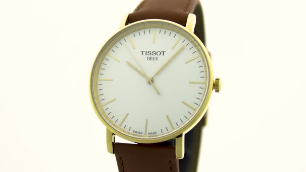 Le Locle, Швейцарія 15.01.2020 - Tissot man watch less steel case, gold PVD covering white clock face dial, ather strap, swiss quartz meticical watch isolated, swiss made production — стокове відео