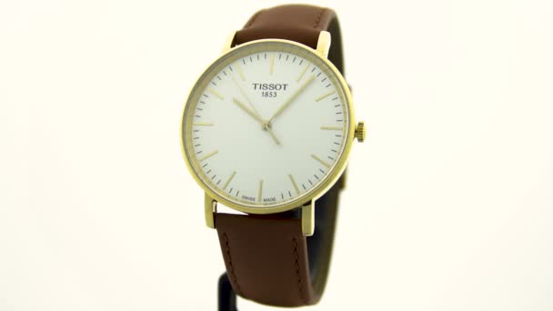 Le Locle, Швейцарія 15.01.2020 - Tissot man watch less steel case, gold PVD covering white clock face dial, ather strap, swiss quartz meticical watch isolated, swiss made production — стокове відео