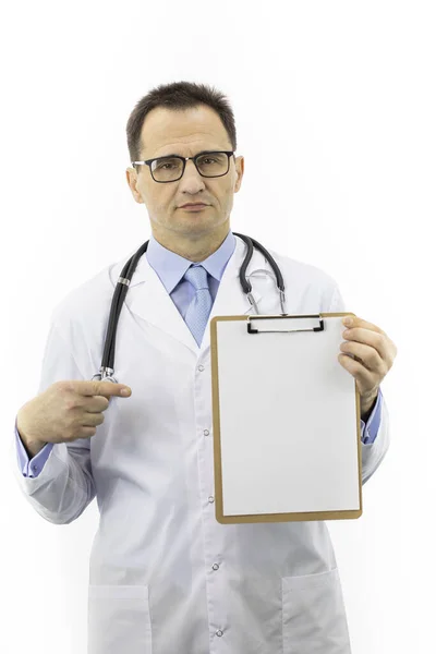 Médico de la tercera edad con abrigo médico apuntando al portapapeles con papel en blanco — Foto de Stock