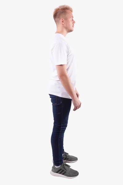 Man stands sideways to camera and looks ahead. Full length. White background — Stock Photo, Image