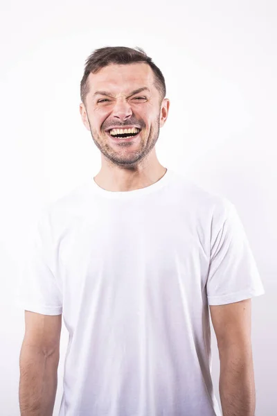 Attraktive glückliche Mann lächelt freudig breit. Weißer Hintergrund. Menschliche Emotionen — Stockfoto