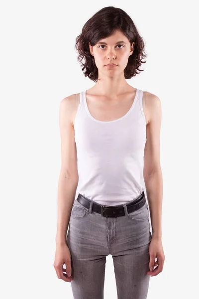 Caucasian girl standing straight, looking directly at camera. White background — Stock Photo, Image